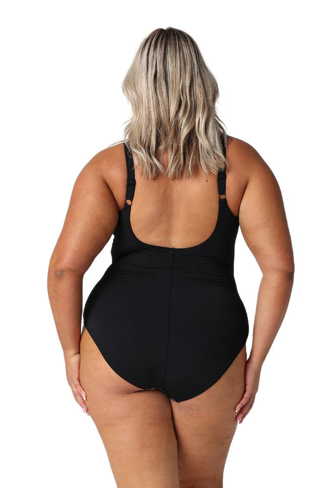 Model showing back of black floral swimsuit