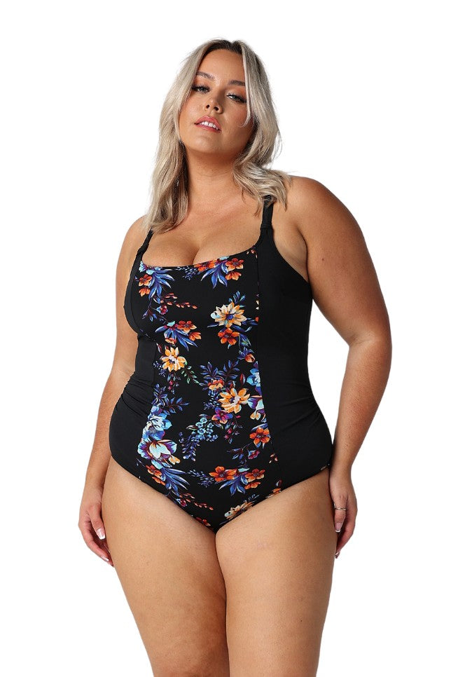 Model wearing black based floral one piece swimsuit