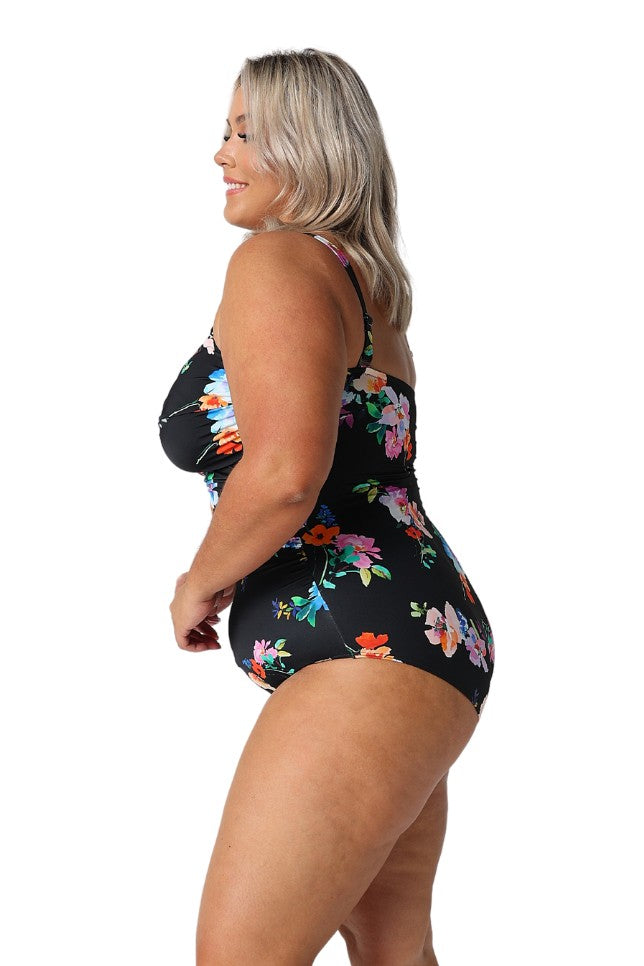 Model showing side of black floral swimsuit