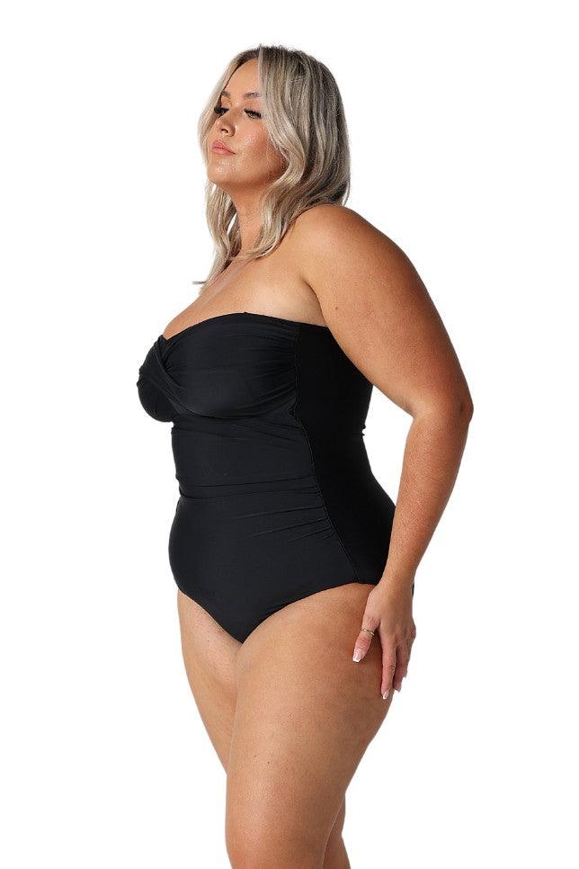 Model showing side of black strapless bandeau one piece