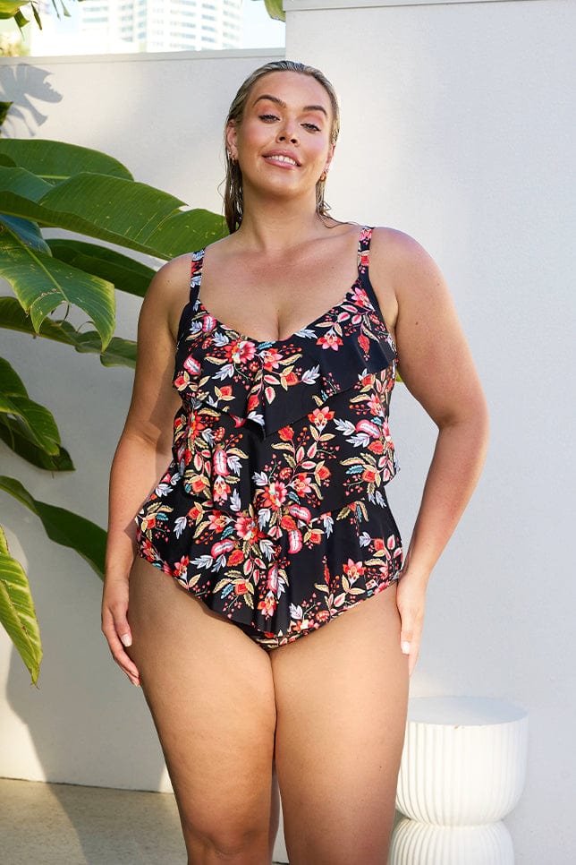 Model wearing black and red floral 3 tier one piece