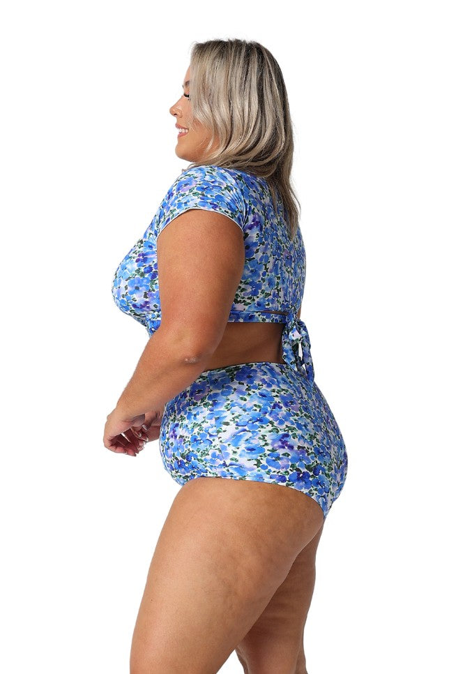 Model showing side of floral blue high waisted swim pant