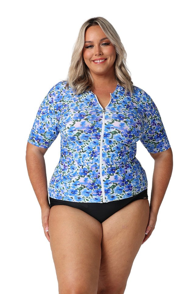 Model wearing blue floral zip front rash vest