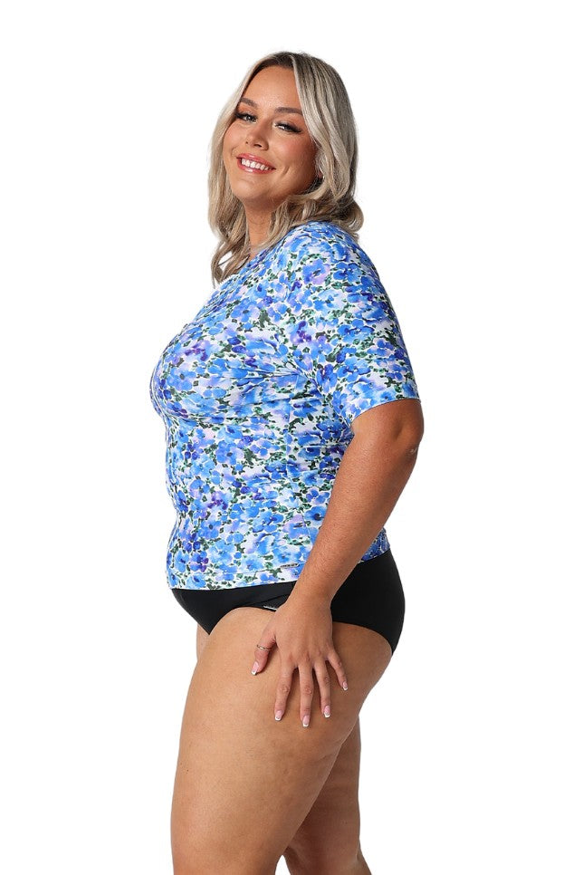 Model showing side of blue floral zip up rash vest