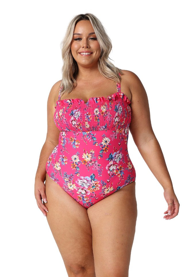 Model wearing hot pink floral shirred one piece swimsuit