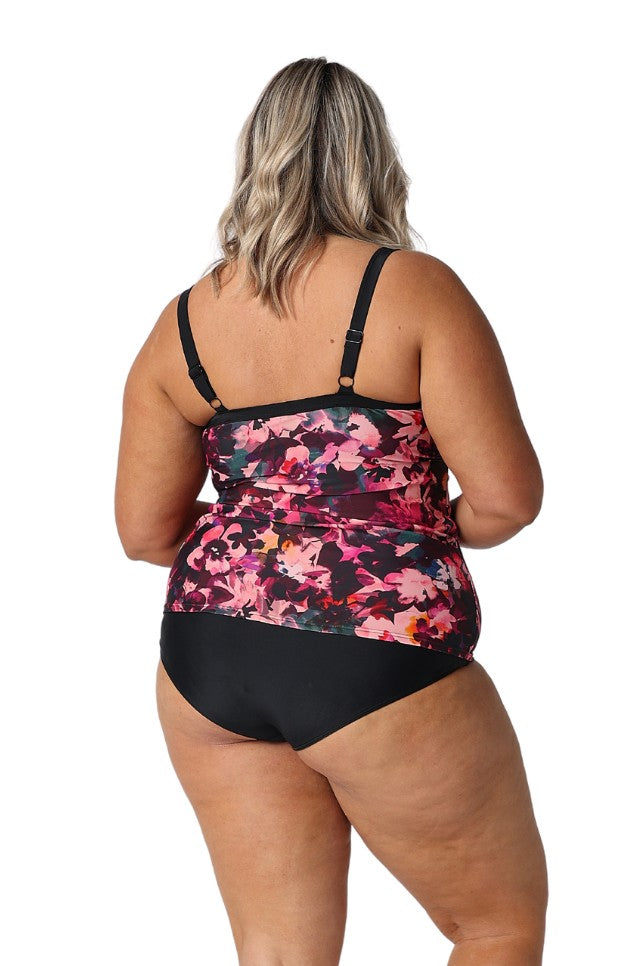 Model showing back of pink and black floral tankini with matching black bottoms