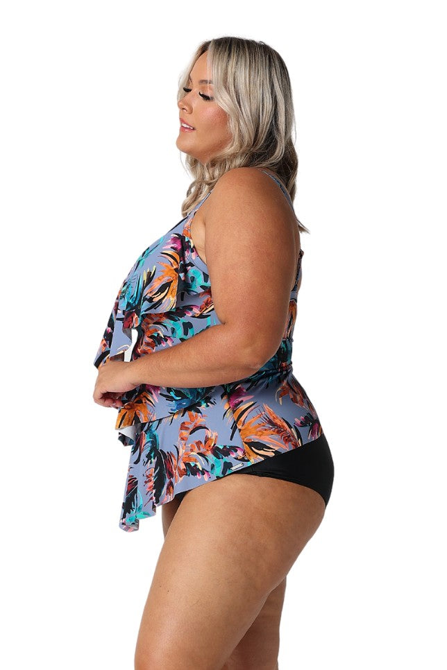 Model showing side of tropical print ruffled tankini top