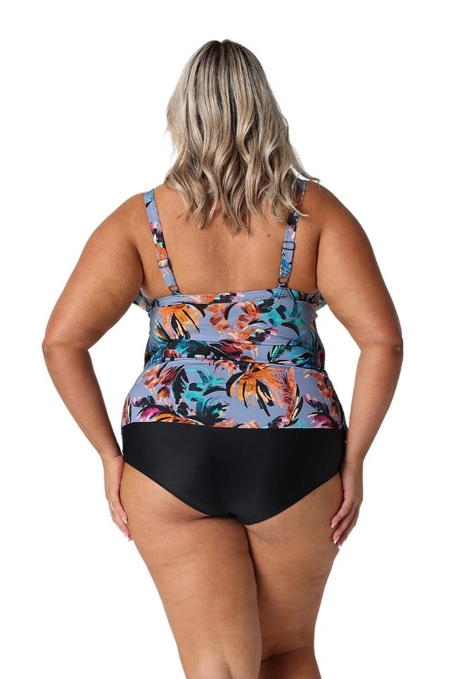 Model showing back of faded blue tropical print tankini top