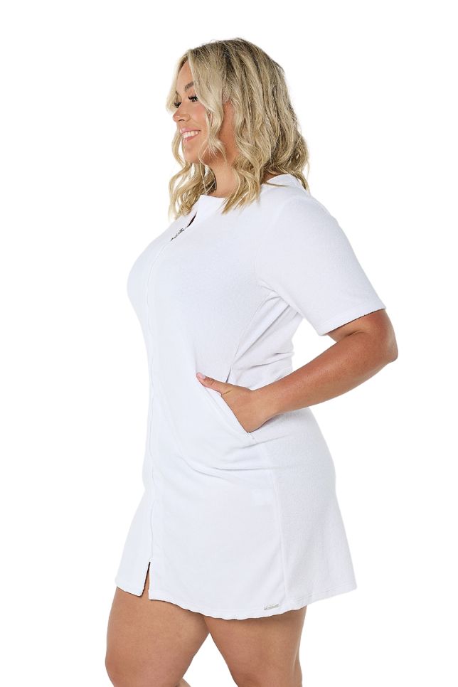 Model showing side of white terry towelling dress with zip front