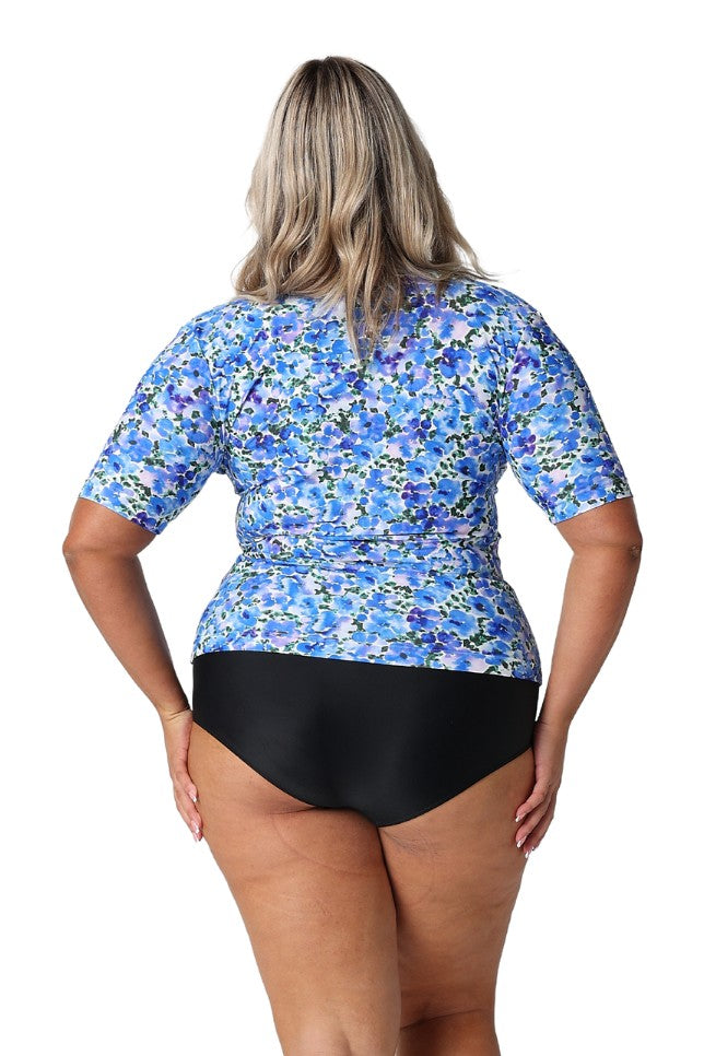 Model showing back of blue floral short sleeve rash vest