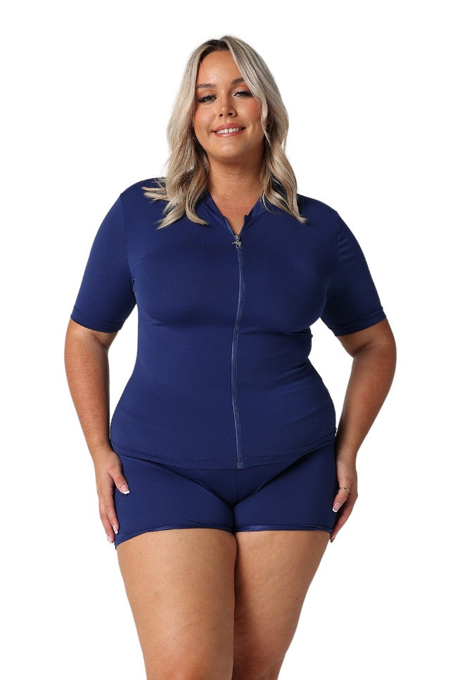 Model wearing navy short sleeve zip front rash vest