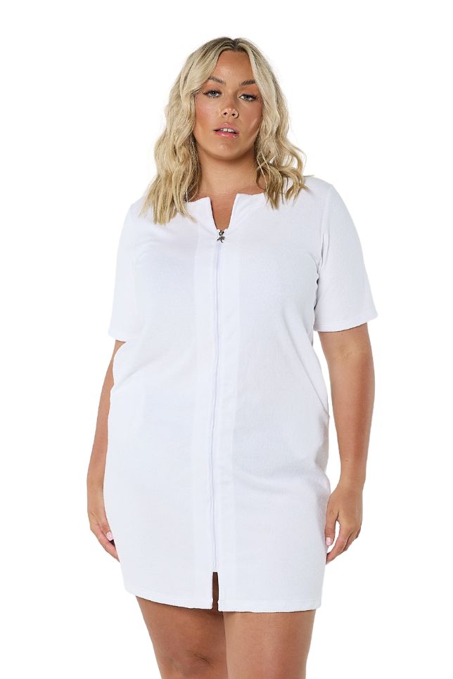 Model wearing white terry towelling dress with zip front