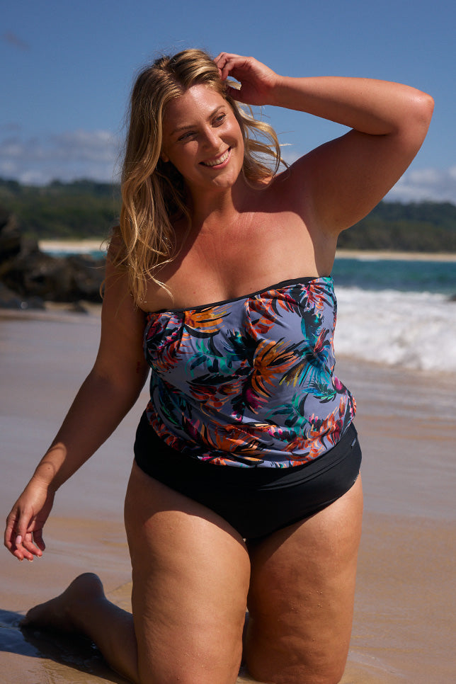 model wearing blue-grey tropical print strapless tankini