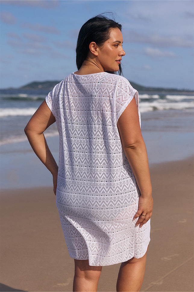 model showing back of white mesh cover up