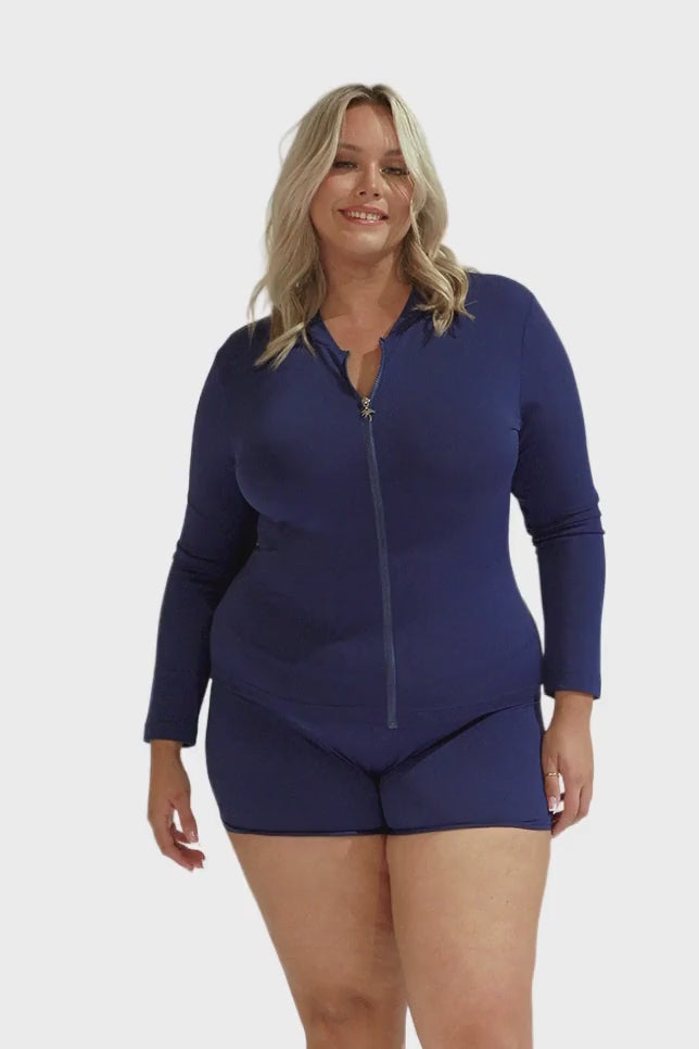 Blonde model wearing navy long sleeve rash vest