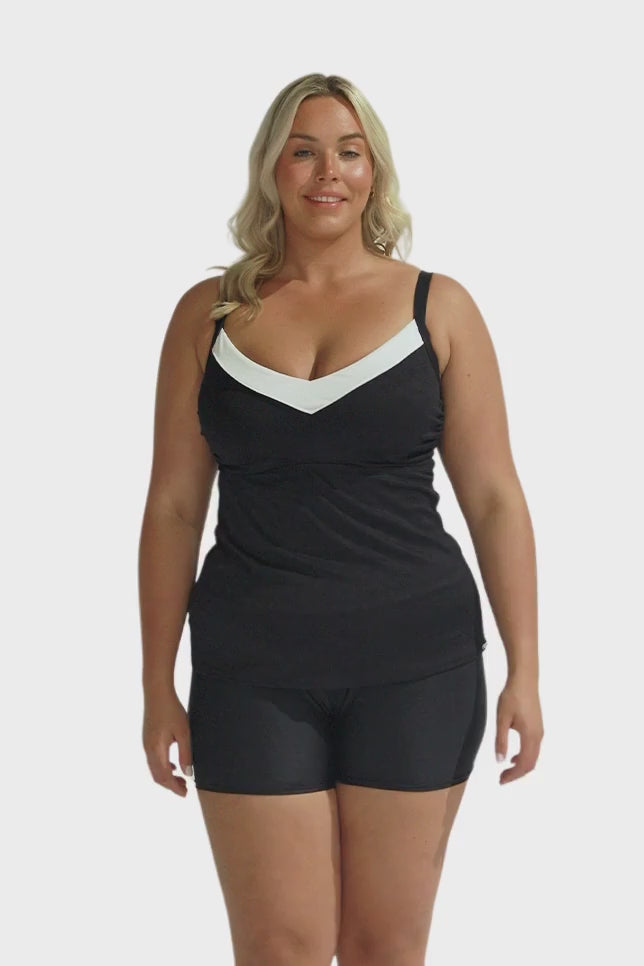 Blonde model wearing black and white underwire tankini top