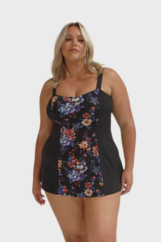 Model wearing black, blue and orange floral swim dress