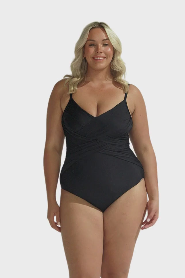 Blonde model wearing black criss cross one piece