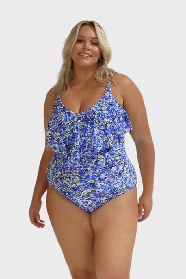 Model wearing blue floral frill v neck one piece swimsuit